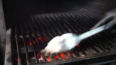 The chef prepares a Josper grill with coals for searing steaks. Stock Footage 325082099
