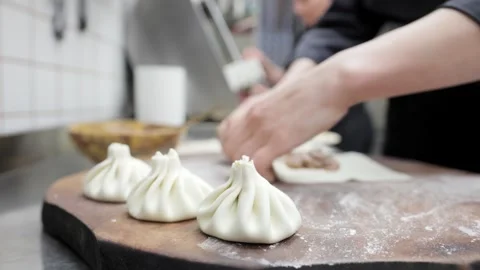 Chef Prepares Khinkali in Restaurant Kitchen, Close-Up of Hands Stock Footage 288575614