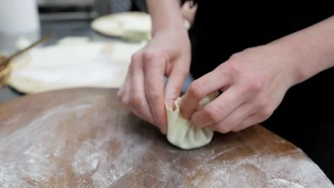 Chef Prepares Khinkali in Restaurant Kitchen, Close-Up of Hands Stock Footage 288575677