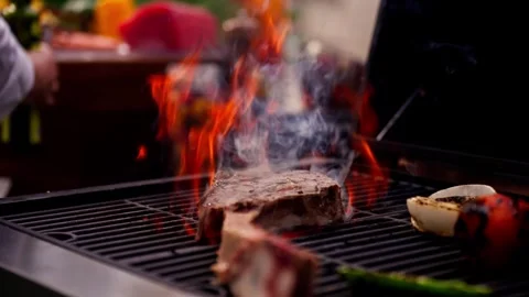 Chef Prepares Large Bone-in Ribeye Tomahawk Steak On Fire Grill Stock Footage 288038752