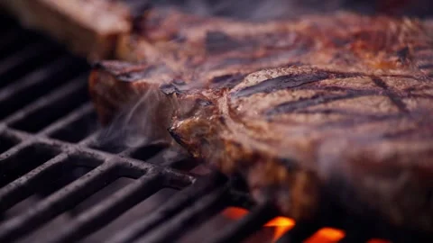 Chef Prepares Large Bone-in Ribeye Tomahawk Steak On Fire Grill Stock Footage 288038753