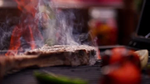 Chef Prepares Large Bone-in Ribeye Tomahawk Steak On Fire Grill Stock Footage 288038760