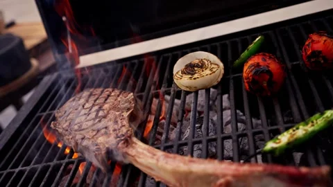Chef Prepares Large Bone-in Ribeye Tomahawk Steak On Fire Grill Stock Footage 288038764