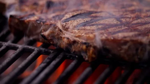 Chef Prepares Large Bone-in Ribeye Tomahawk Steak On Fire Grill Stock Footage 288038767