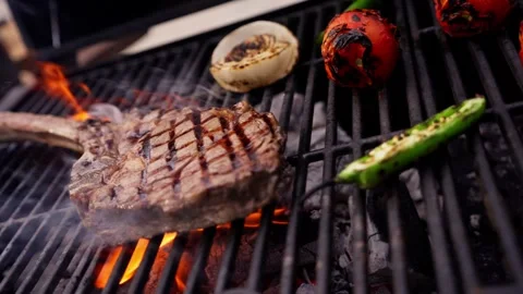 Chef Prepares Large Bone-in Ribeye Tomahawk Steak On Fire Grill Stock Footage 288038768
