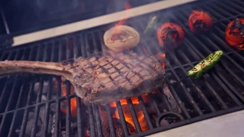 Chef Prepares Large Bone-in Ribeye Tomahawk Steak On Fire Grill Stock Footage 288038772