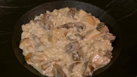 A chef prepares mushroom risotto. Slow motion. Stock Footage 303746673