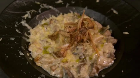 A chef prepares mushroom risotto. Slow motion. Video stock 303746750