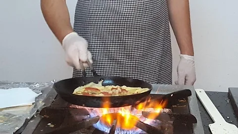 Chef prepares omelette with vegetables and grated cheese Stock Footage 112201602