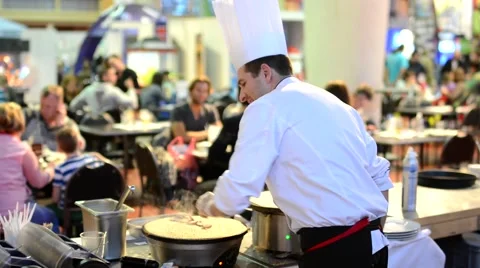 Chef prepares a pancake - restaurant with people in background Stock Footage 44404864