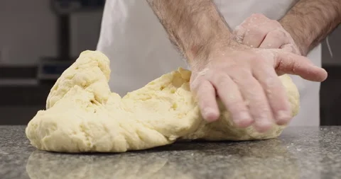 Chef prepares pasta, kneading dough with hands. Traditional Italian pasta recipe Stock Footage 269790551