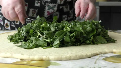The chef prepares a pie stuffed with sorrel Stock Footage 197932564