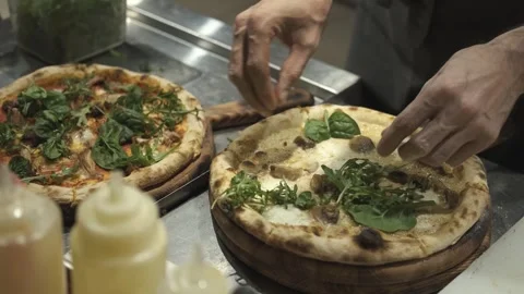 The chef prepares pizza decorating it with herbs Video stock 247030660