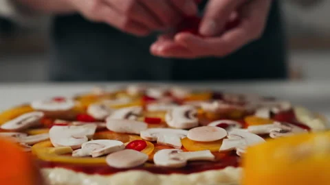 Chef prepares pizza on the dough hands put the toppings the process preparin Stock Footage 221153300