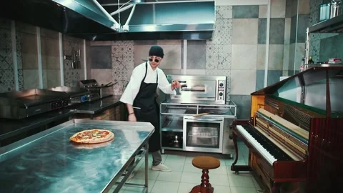 The chef prepares pizza in the kitchen. Video stock 154455921