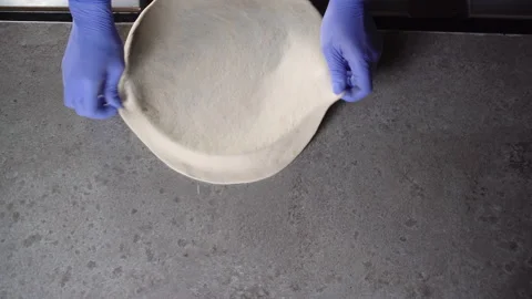 The chef prepares pizza, puts a raw piece of dough on the mold. Copy space. Video stock 150557749
