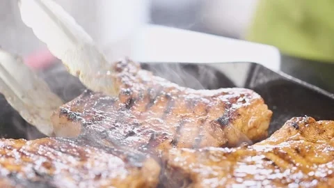 Chef prepares pork chops on a grill pan. 스톡 동영상 159401361