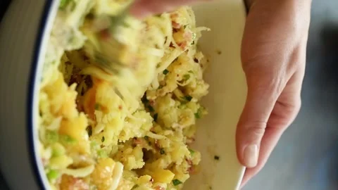 The chef prepares potato and bacon patties. Mixing ingredients in a bowl. Stock Footage 305154703