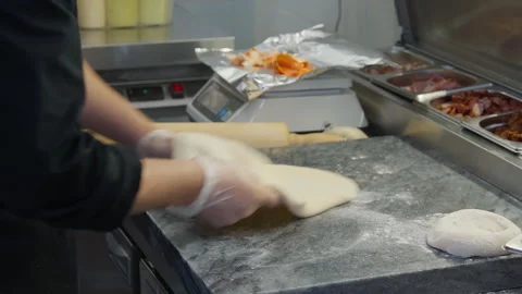 Chef prepares the the raw dough ingredient for italian pizza food cooking Stock Footage 248551695