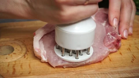 Chef prepares a raw piece of pork meat Stock Footage 199038001