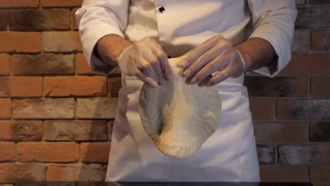 Chef prepares raw pizza dough. Hands knead the dough close-up. Stock-Footage 132828505