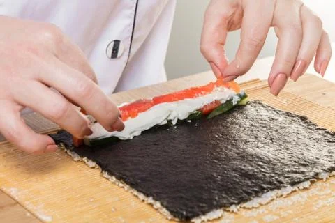 Chef prepares rolls, hands closeup Stock Photos