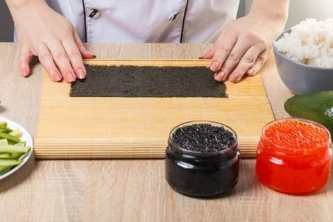 Chef prepares rolls, hands closeup Stock Photos