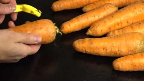 Chef prepares salad and quickly cleans carrots. Stock Footage 143352192