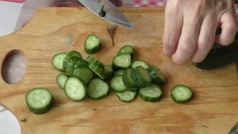 The chef prepares a salad of fresh cucumbers.  healthy food concept Stock Footage 154055178