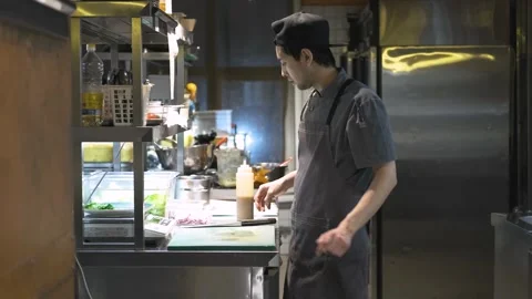 Chef prepares salad in restaurant kitchen Stock Footage 247030838