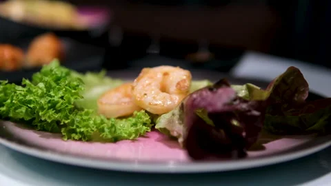 Chef prepares salad with rocket avocado and shrimp. Ingredients combined for Video stock 302088336