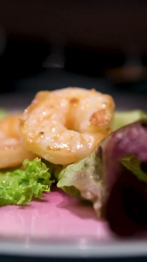 Chef prepares salad with rocket avocado and shrimp. Ingredients combined for 動画素材 302802053