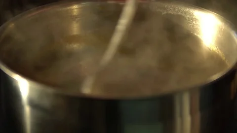 The chef prepares sauce with tomato in a saucepan. Stock Footage 75156306