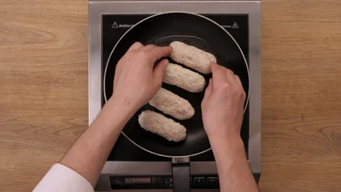 Chef prepares schnitzel in a frying pan. cooking process. top plan  Video stock 164096982