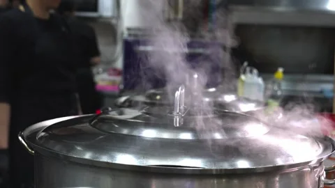 Chef prepares soup, water and steam evaporating from pot in kitchen Stock Footage 267669254