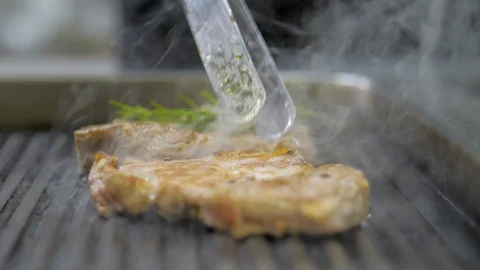 The chef prepares a steak in the restaurant's kitchen Stock Footage 125070739