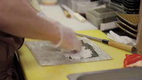 Chef prepares sushi in kitchen of restaurant Stock Footage 75738097