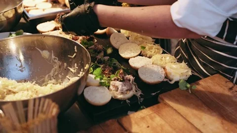 Chef prepares tiny burgers for party snack Video stock 76827215