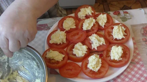 Chef prepares tomatoes with cheese and garlic Stock Footage 187639168