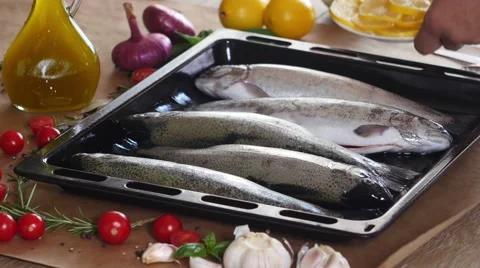 The chef prepares a trout for baking in the oven Stock Footage 68808532