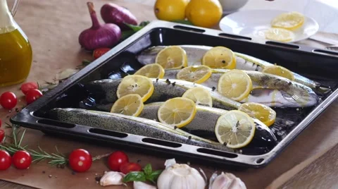 The chef prepares a trout for baking in the oven Stock Footage 68810197