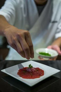 The chef prepares tuna sashimi. The process of making and decorating sashimi Stock Photos