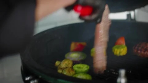 The chef prepares vegetables and meat on the grill Stock Footage 131152132