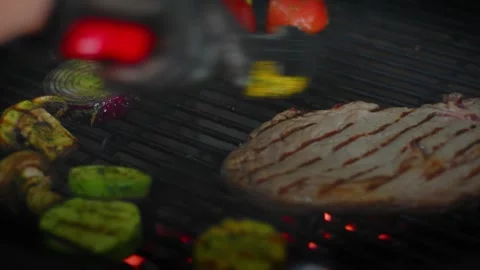 The chef prepares vegetables and meat on the grill Stock Footage 131152134