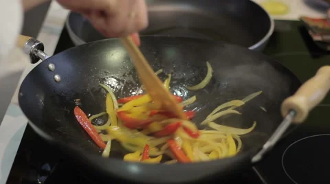Chef prepares vegetables in a frying pan 스톡 동영상 52784044