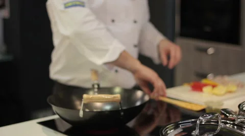 Chef prepares vegetables in a frying pan 스톡 동영상 52784713