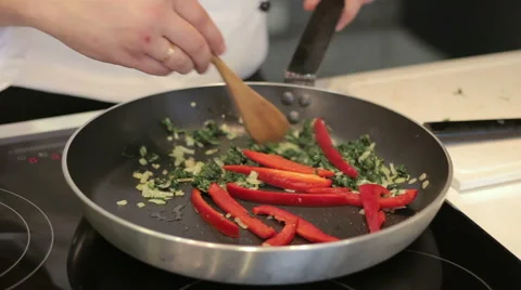 Chef prepares vegetables in a frying pan 스톡 동영상 52796877
