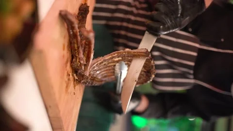 Chef prepares well-cooked ribs ready to eat with a knife (Vertical) Stock Footage 181863365