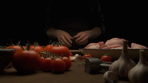 The chef prepares the whole chicken for frying on the table with vegetables Stock Footage 137800973