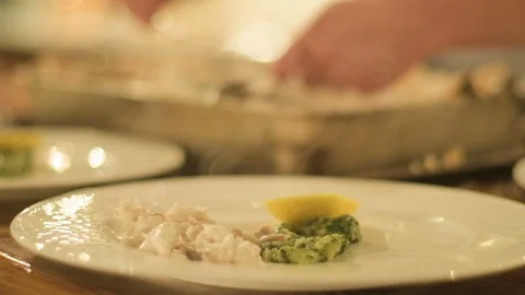 Chef preparing and decorating fish, many round plates with meal 스톡 동영상 96031528